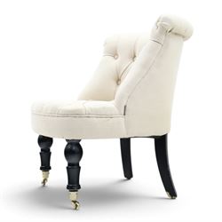 Victorian style upholstered tub chair, buttoned cream fabric back and seat with rolled sides, on ebonised turned front supports with brass castors and splayed rear supports