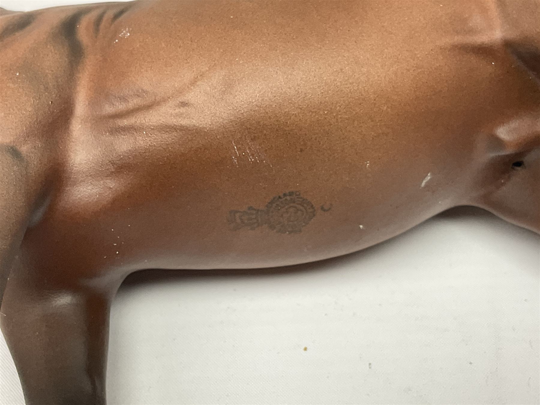 Four Beswick horse figures, comprising Quarter Horse, two Shires no 818 and matt palomino, together with Beswick donkey and Royal Doulton horse on a wooden plinth  