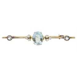 Early 20th century gold aquamarine and diamond brooch, the oval central aquamarine of approx 3.10 carat, set with three old cut diamonds either side and two aquamarines to each end