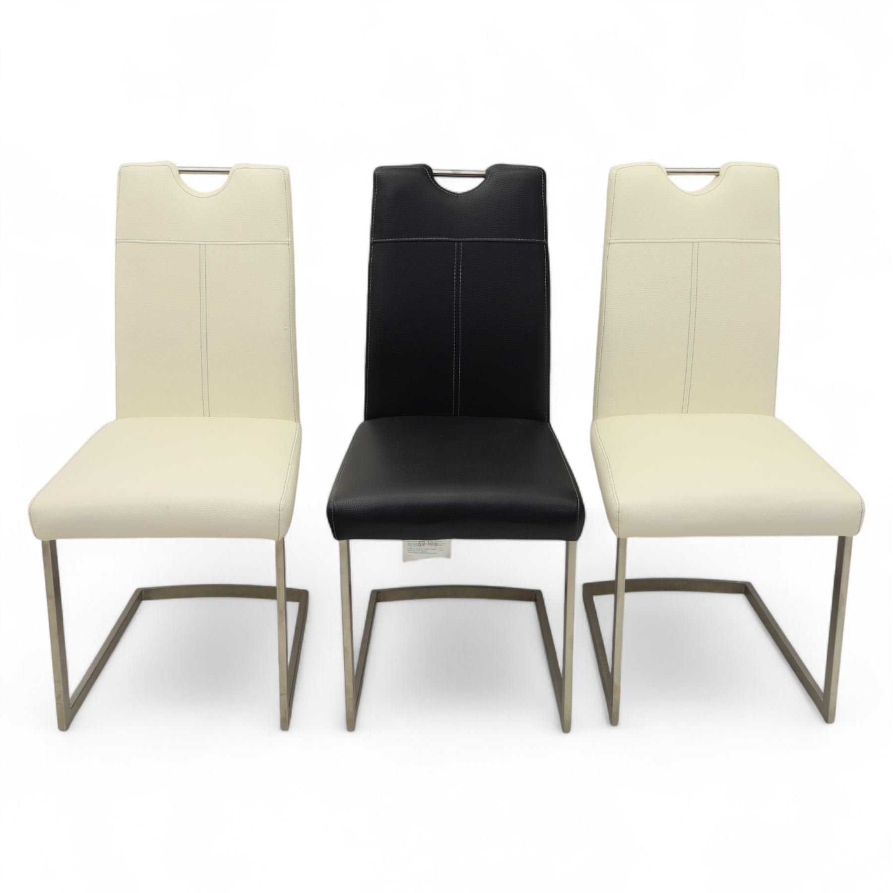 Set of seven contemporary style dining chairs, each with a high padded back and seat upholstered in faux leather on brushed steel sled bases  