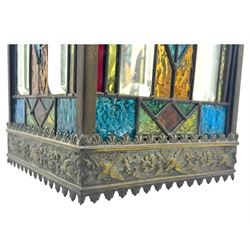 20th century Gothic design stained glass and brass hall lantern, with ornately decorated frieze and apron, with geometric coloured glass panels and eight rectangular bevelled glass panels, with bell shade, wired for electricity 