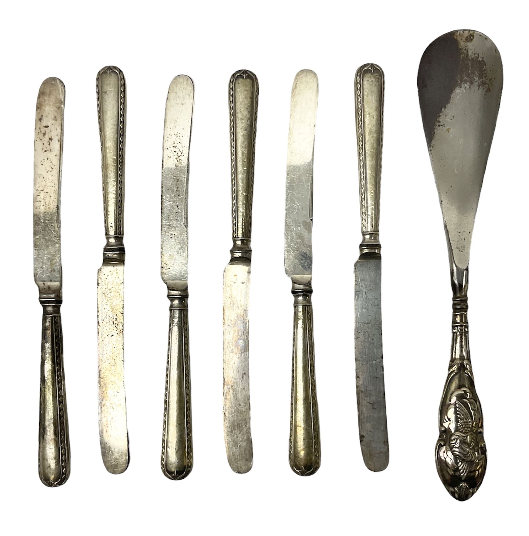 Set of six silver handled butter knives, and a silver handled shoehorn, all hallmarked, but hallmarks worn and indistinct