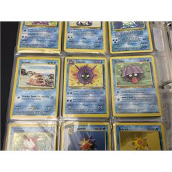 Collection of Pokemon trading cards, mostly 1999 Wizards Pokemon cards to include holo Charizard 4/102, first edition holo Machamp 8/102, further holographic cards; Dark Flareon 35/82 and Dark Vaporeon 45/82, cards from themed sets and 4th edition prints; 1998 Electronic Pokédex with cardboard boxes for themed decks Blackout, Overgrowth and Power Reserve Jungle, along with a large quantity of energy and trainer cards 