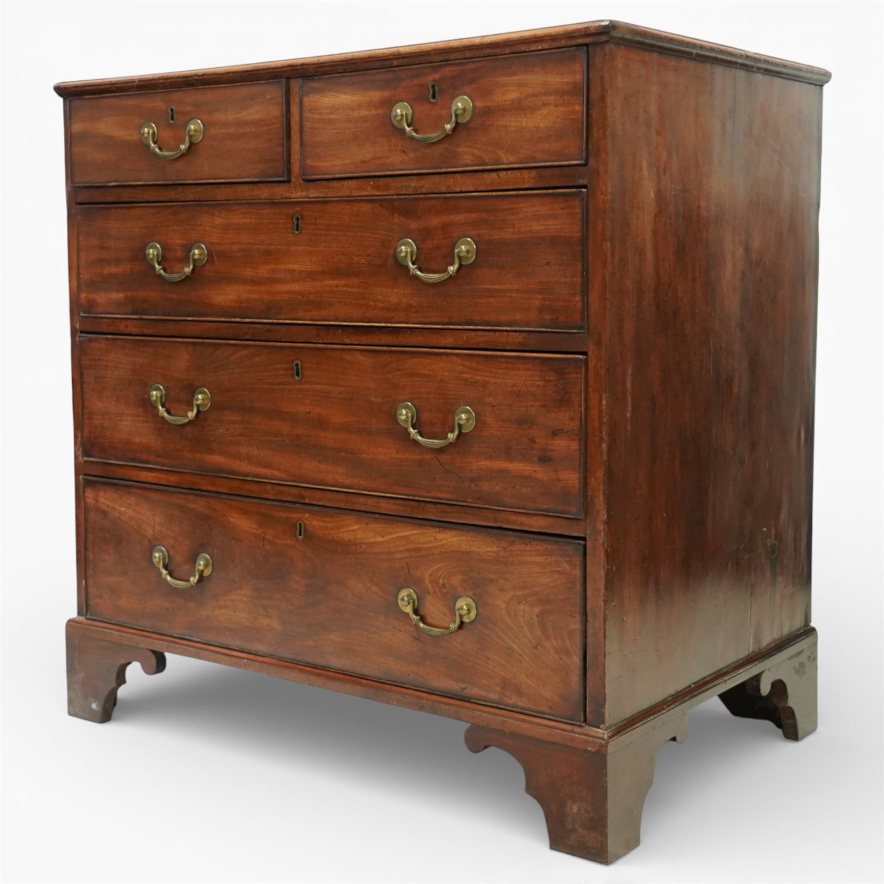 George III mahogany chest of drawers, moulded rectangular top over two short and three long drawers, plain frieze, the drawers fitted with brass swan neck handles and pierced escutcheons, raised on shaped bracket feet