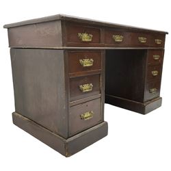 Late Victorian mahogany twin pedestal desk, moulded rectangular top with inset writing surface, fitted with nine drawers, moulded uprights, on moulded plinth base