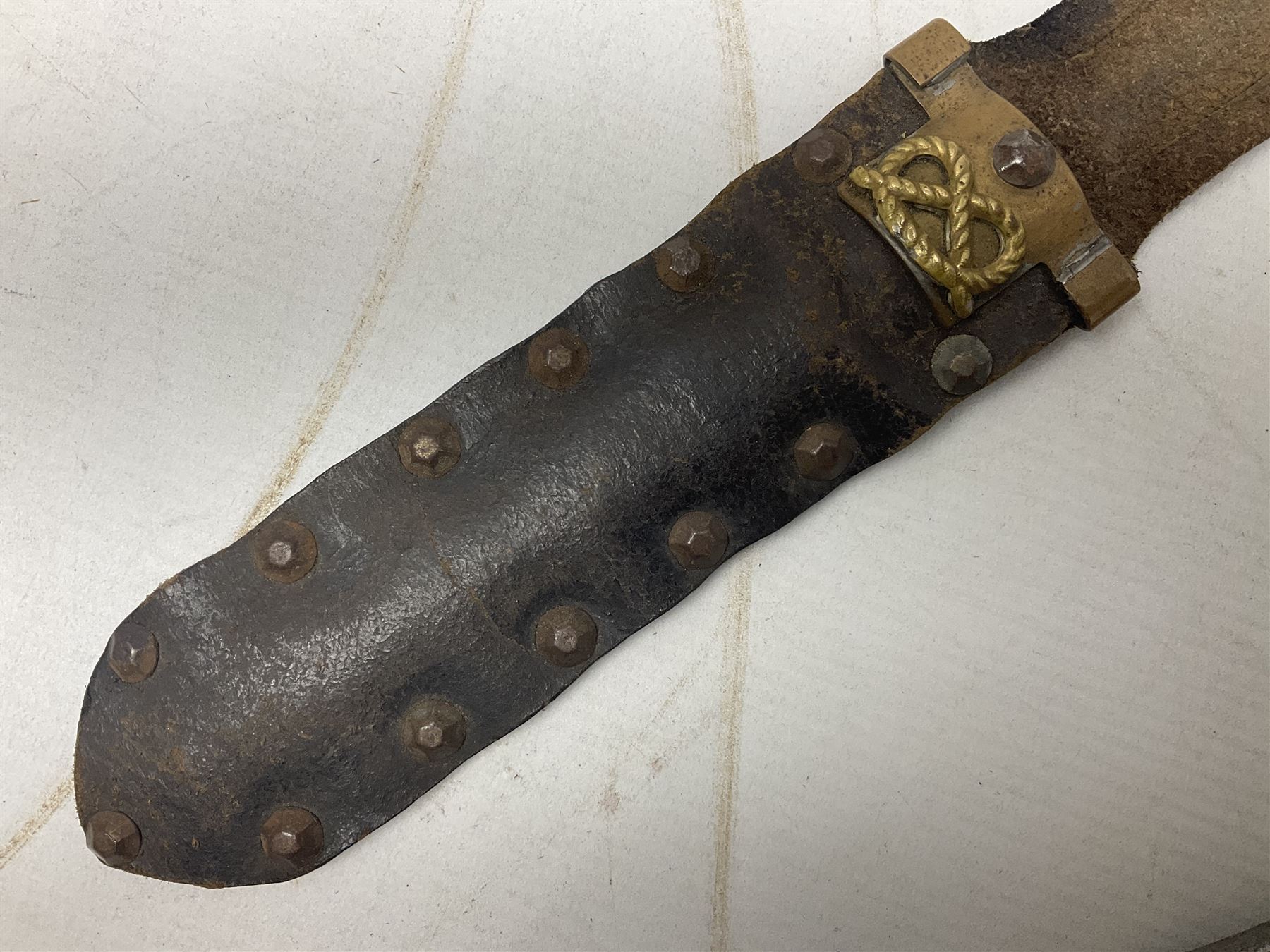 Scratch-built fighting/throwing knife, probably trench art, with 18cm steel spear type blade, plain cross-piece and French Lebel Rifle bayonet grip; in bras mounted studded leather sheath with belt hanger L29.5cm overall