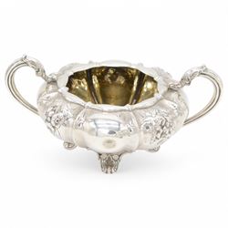 William IV silver twin handled sucrier and milk jug, each of circular bellied form, embossed with floral decoration, upon four pad scroll feet, hallmarked London 1831, maker's marks CE, including handles H10cm