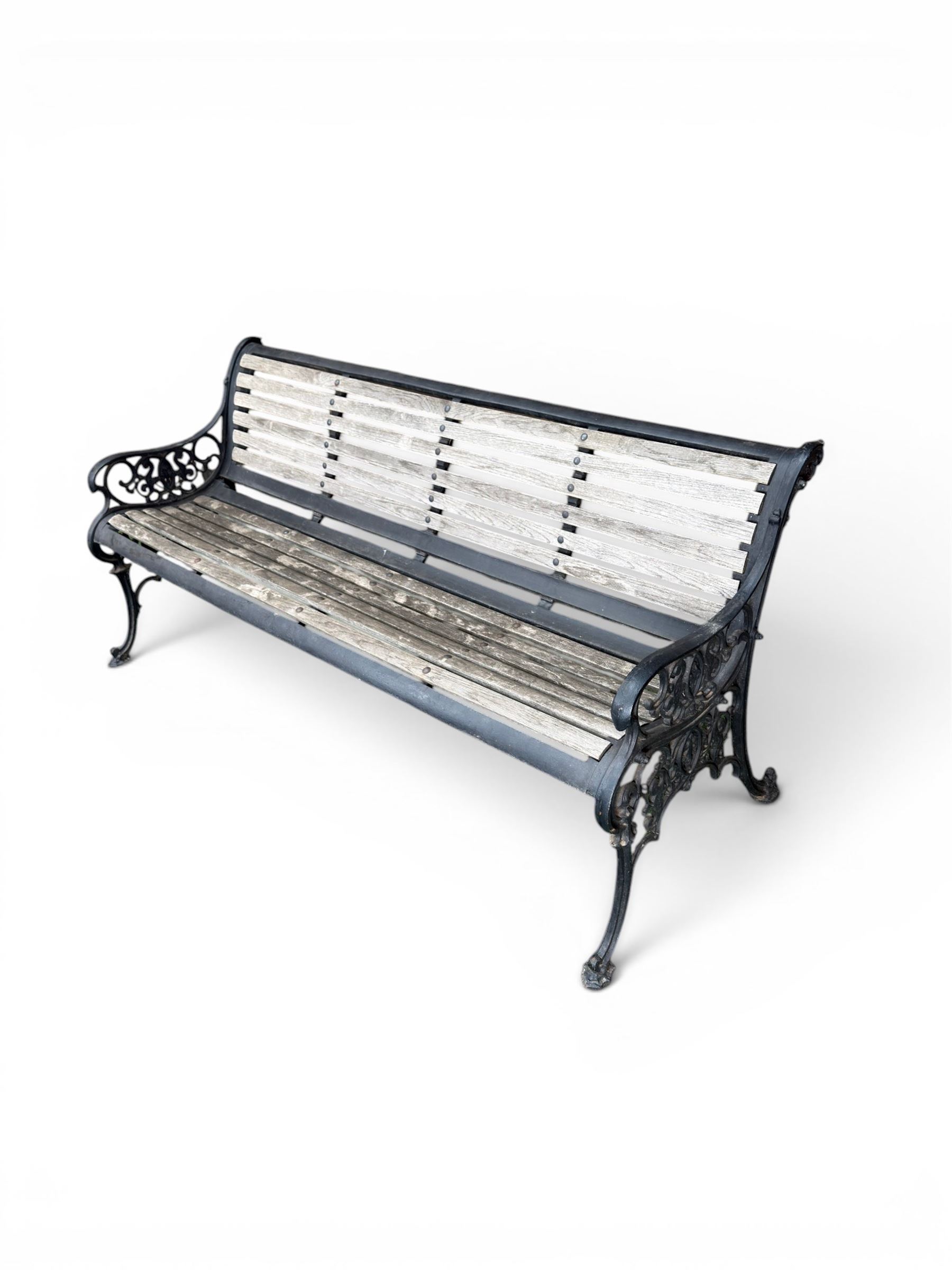 Victorian Andrew McLaren pattern cast iron bench, the ornate ends with detailed scrollwork, joined together with a cast iron seat and backrest frame supporting gently weathered oak slats, Victorian diamond stamp mark