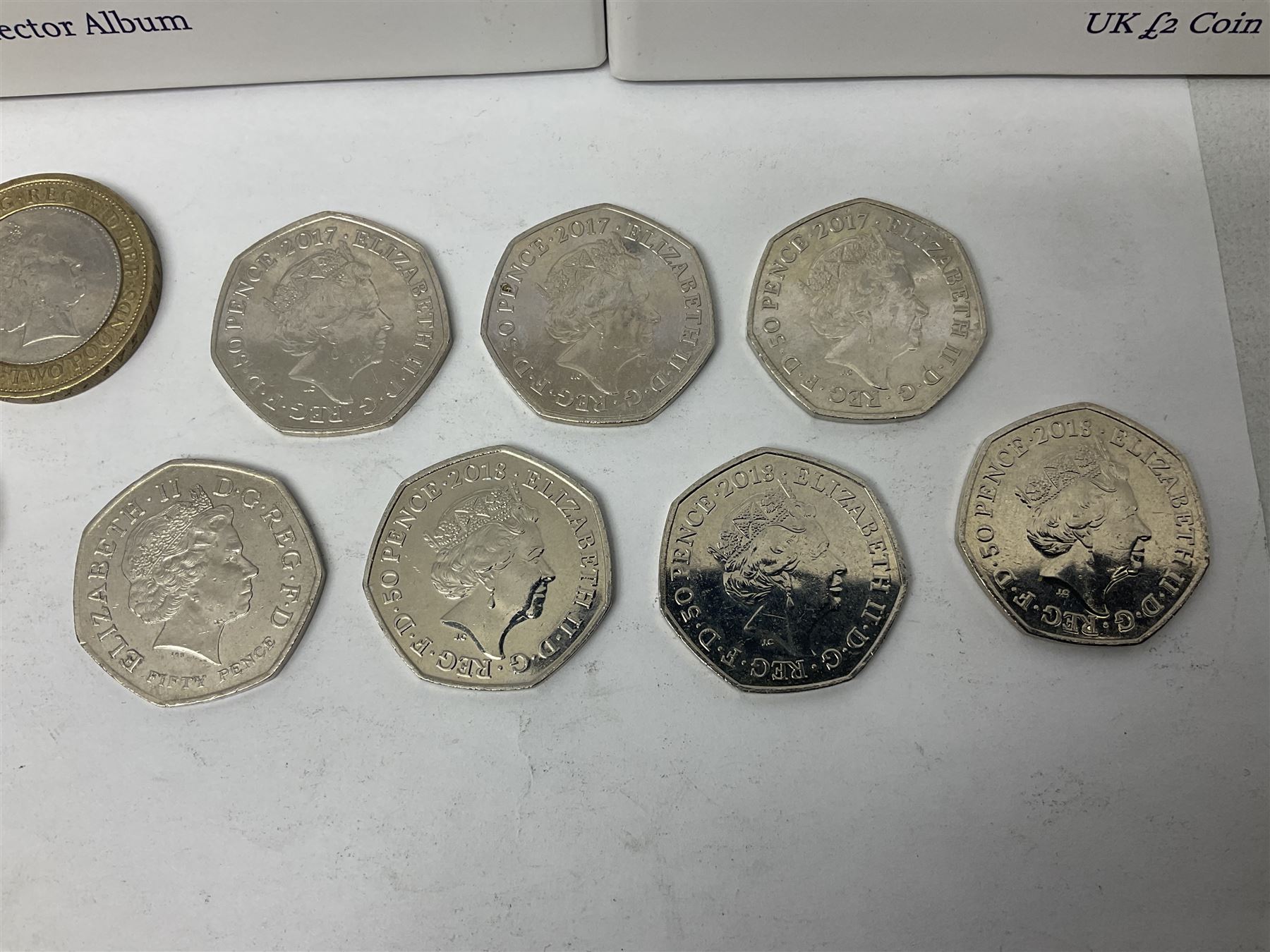 The Royal Mint United Kingdom mostly commemorative two pound, old round one pound and fifty pence coins, overall face value approximately 110 GBP, housed in three 'Coin Hunt' folders and loose