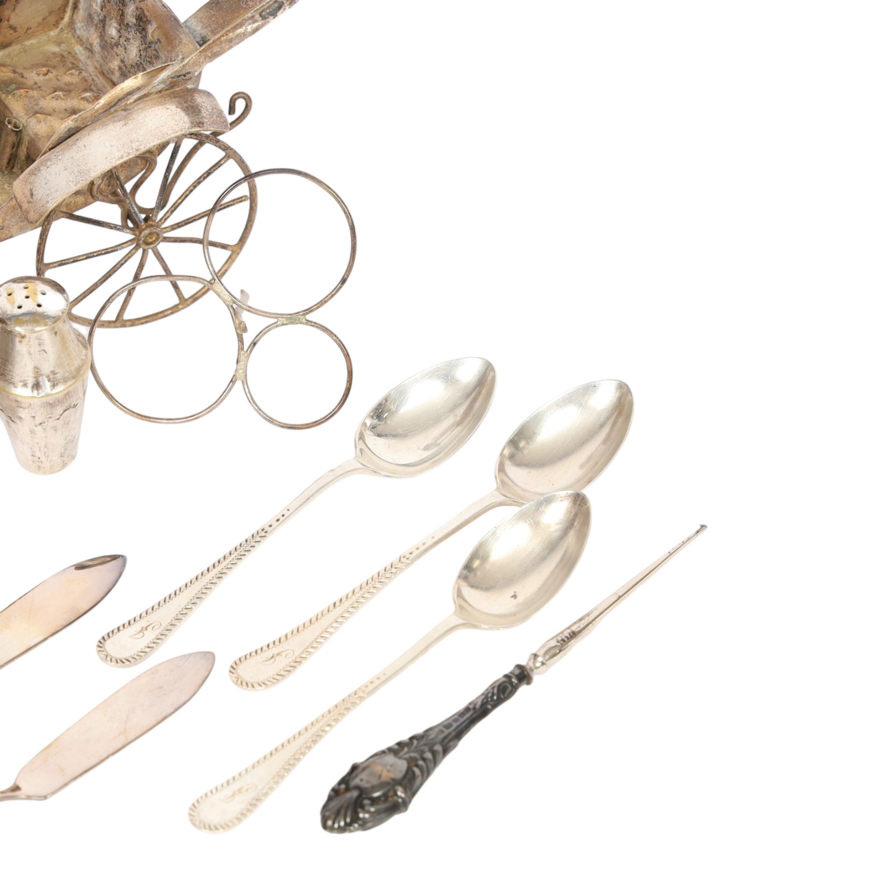 Silver cutlery comprising three teaspoons and two butter knives, a silver handled hook and a silver plated Chinese rickshaw cruet