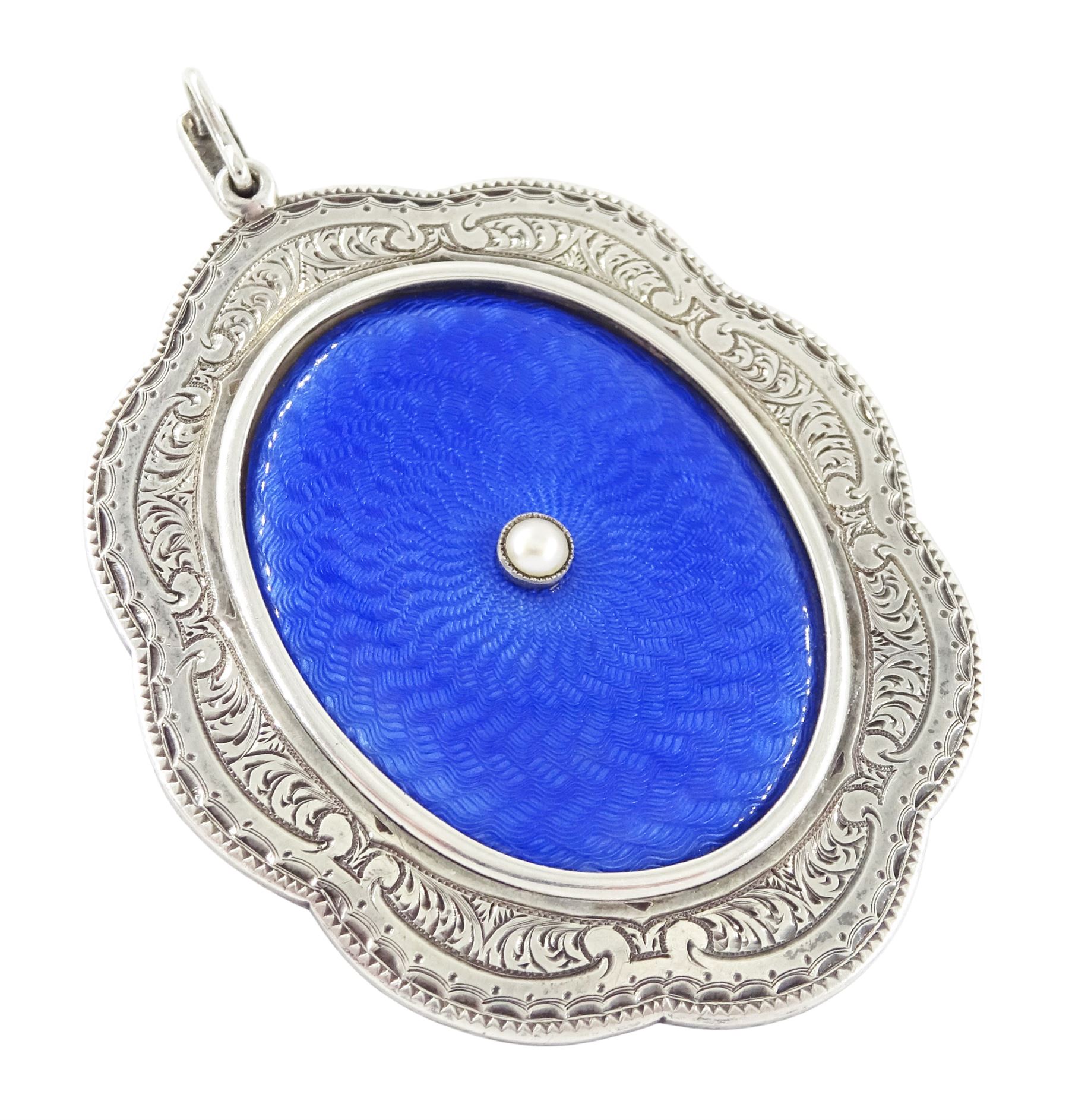 Early 20th century silver guilloche enamel portrait pendant, set with an oval miniature of a gentleman wearing a grey suit on ivory, within a blue enamel and marcasite border, the reverse set with a blue enamel panel and single split pearl, within a silver engraved border, suspended from a marcasite bail

This lot has been registered for sale under Section 10 of the APHA Ivory Act