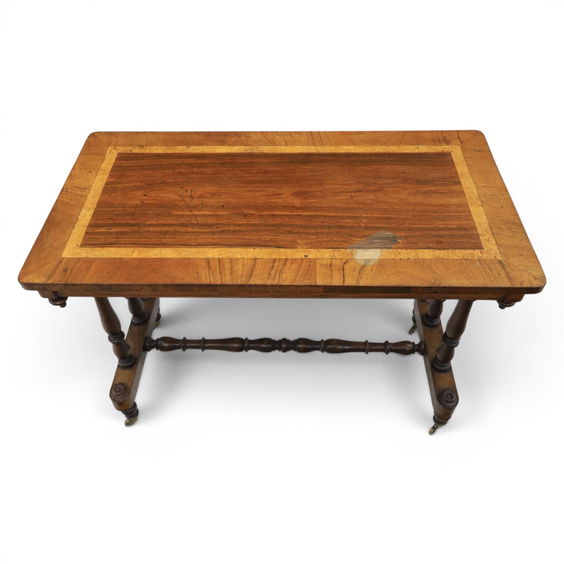 Victorian rosewood and beech stretcher table, rectangular walnut banded top, four turned legs and stretcher, raised on brass castors