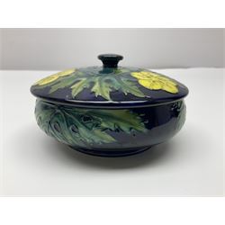 Moorcroft dish and cover, of circular form, decorated in Buttercup pattern, together with a Moorcroft vase, of baluster form, decorated in Magnolia pattern, both with printed marks beneath, tallest H9.5cm