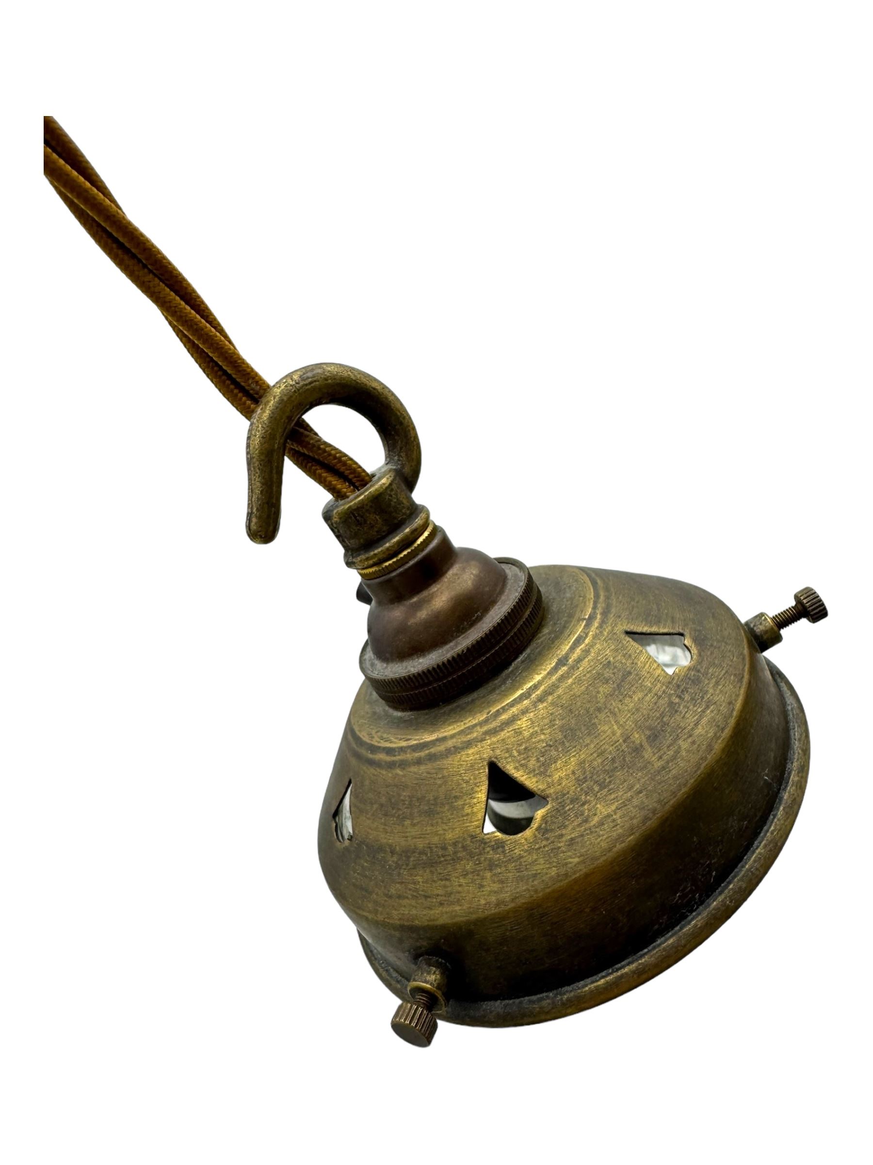 Set of two small and two large pendant lights, each with clear glass spherical shade with moulded swirl pattern, suspended from twisted cords, brass ceiling rose