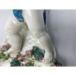 Victorian wall pocket by Moore Brothers retailed by T.Goode modelled as a semi nude white glaze cherub with turquoise ribbon, with encrusted floral decoration, the reverse stamped ‘T.Goode & Co.’, H32cm