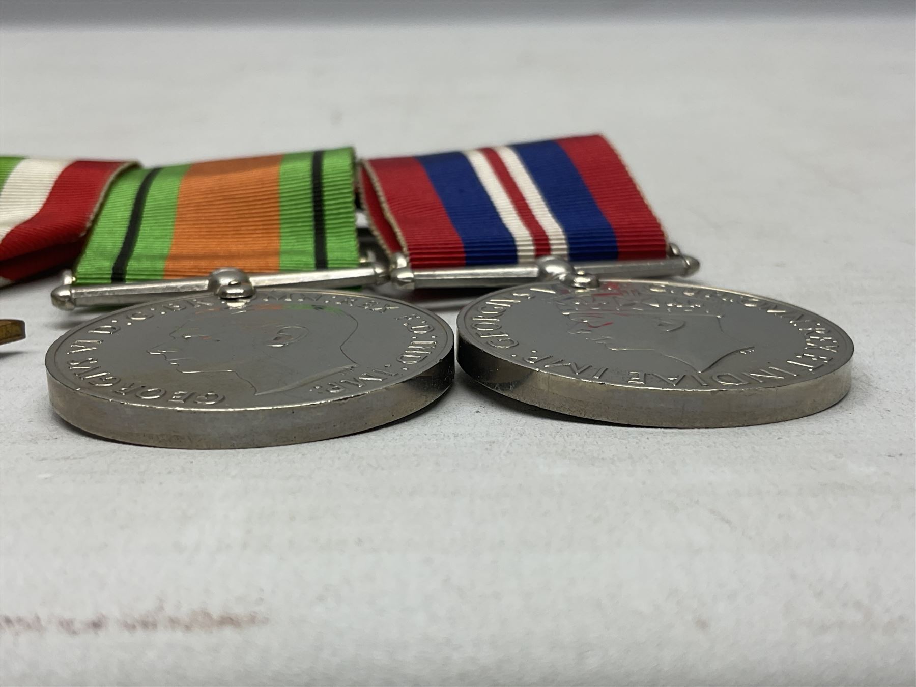 WW2 group of four medals comprising 1939-1945 War Medal, Defence Medal, Italy Star and 1939-1945 Star; with Royal Army Service Corps cap badge and RASC chrome and enamel sweetheart brooch