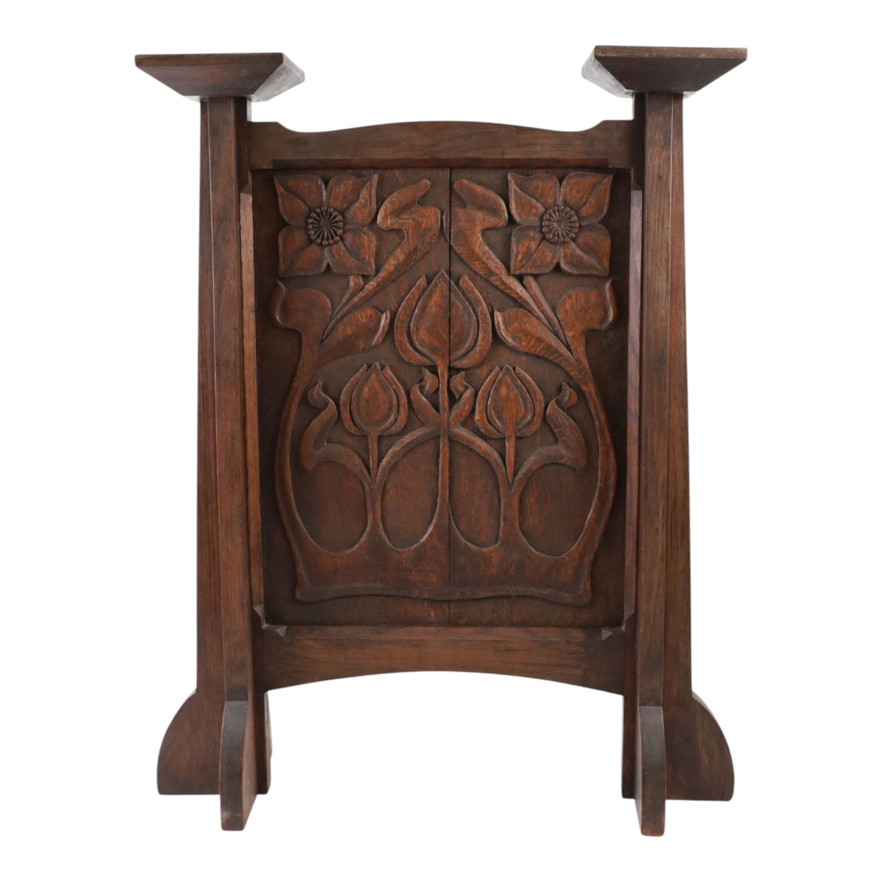 Art and Crafts carved  oak firescreen, the rectangular panel carved with Art Nouveau flowers and foliage, H84cm