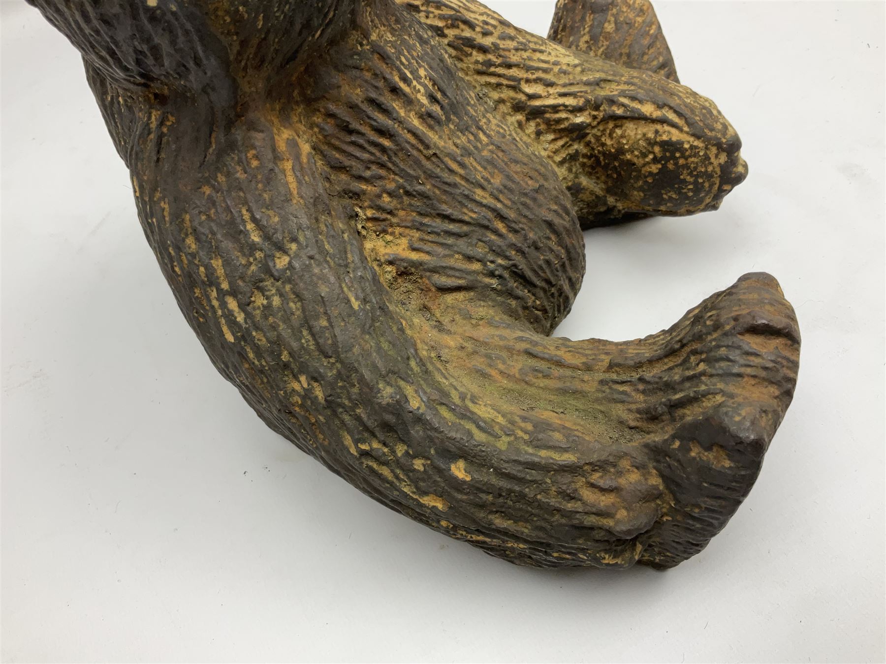 19th century cast iron door stop, modelled as a seated toy bear, with remnants of painted finish, H22.5cm