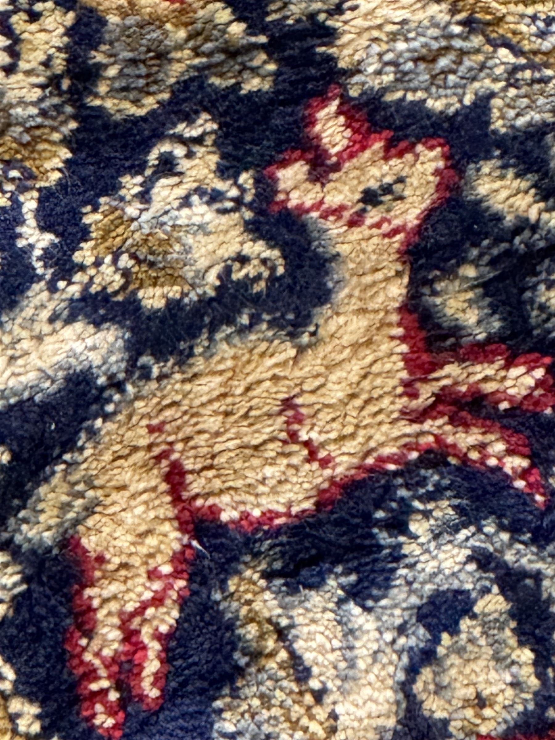 Persian Kerman ivory ground rug, the field adorned with naturalistic depictions of birds, animals and floral designs, framed by a multi-band border in blue and red tones