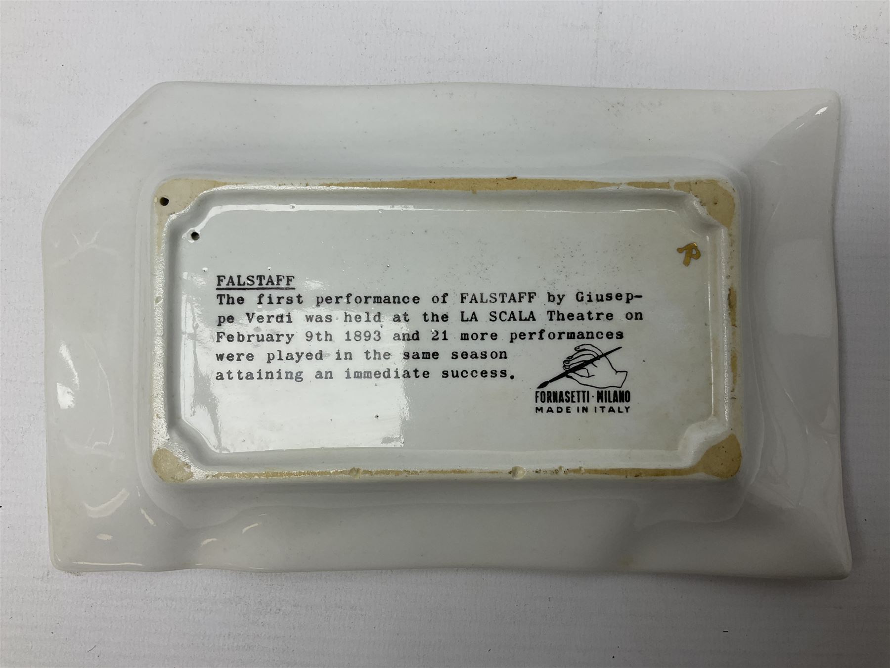 Fornasetti rectangular 'Falstaff' operatic billboard ashtray decorated with black and white text with a gilt border edge,  with printed mark beneath, H22cm 