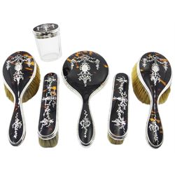 1920's six piece silver and tortoiseshell mounted dressing table set, comprising hand held mirror, two hair brushes, two clothes brushes and glass jar and cover, each with silver inlaid floral and ribbon swag decoration to the tortoiseshell panels, hallmarked Goldsmiths & Silversmiths Co Ltd, London 1929
