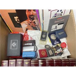Mostly Queen and Freddie Mercury interest items, including pin badges, newspaper cuttings, diecast 'promotional' vehicles, special edition Pop Rocks figure of Freddie Mercury, VHS tapes, two charity certificates signed by Brian May and Roger Taylor, poster etc, in two boxes 