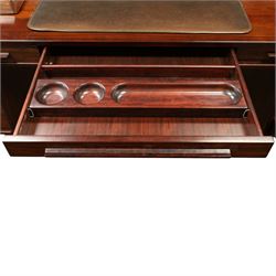 Dyrlund - Santos rosewood office suite, comprising an executive desk and cream leather upholstered swivel chair, the desk with a broad rectangular top with rounded corners, leather writing surface, pen compartments and letter tray, three lockable frieze drawers with fitted interiors above a central kneehole flanked by floating drawer pedestals, the left housing a filing drawer and the right three compartmented drawers, with a full width modesty panel to the reverse, chair raised on a castor base, H 116cm, W 62cm, D 74cm