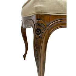 20th century French walnut stool, shaped rectangular seat upholstered in pale fabric, floral carved cabriole supports with scrolled terminals