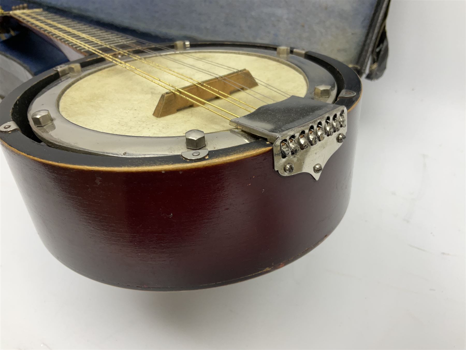 Dulcet eight-string banjo mandolin with mother-of-pearl inlaid ebonised fingerboard L55.5cm; cased; and Irish mahogany bodhran hand drum with inlaid stringing and vellum top D46.5cm; in soft carrying case with double ended beater (2)