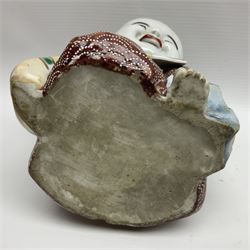 Japanese Fukusuke good fortune figure, modelled as a kneeling male figure holding a fan, dressed in traditional Samurai robes, H15.5cm