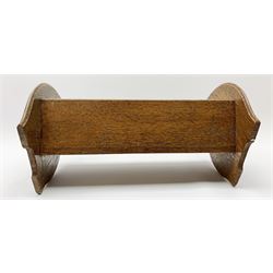 Arts and Crafts oak book trough, the shaped ends with pierced 'handles' and applied copper panels with tendril detail, H23cm L39cm D21cm