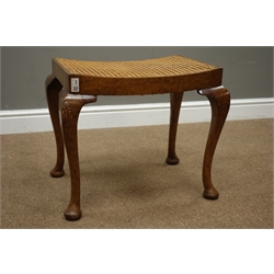  20th century walnut dressing table stool, dished cane work seat, on cabriole supports, W55cm  