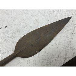 Native long-shafted spear, the large iron head with central medial ridge and decorative neck, on plain circular haft L260cm; and another similar Native long-shafted spear with cane haft L249cm (2)