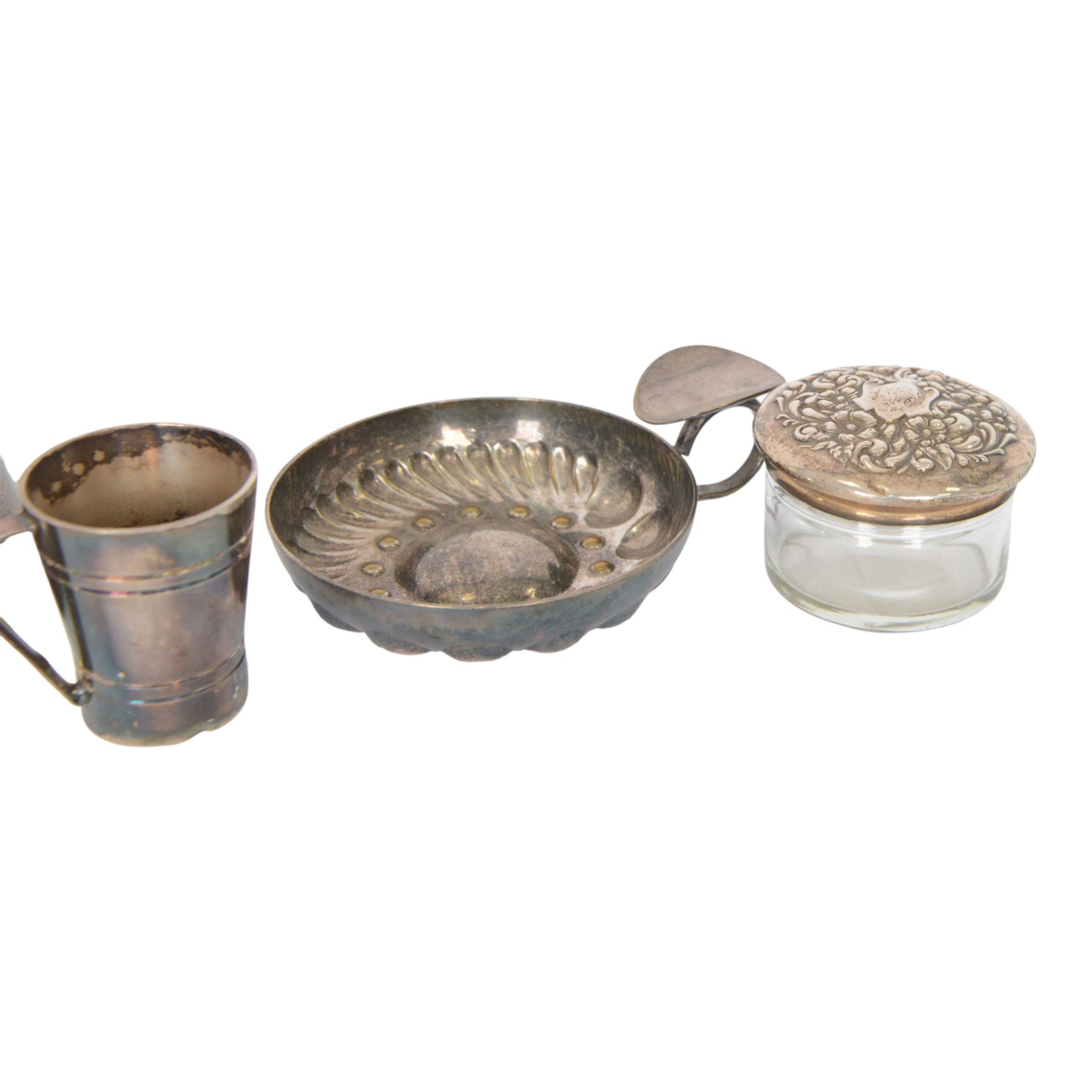 Silver mounted trinket box, with embossed lid, hallmarked, silver lidded glass jar stamped sterling, silver plated measure and a silver plated dish