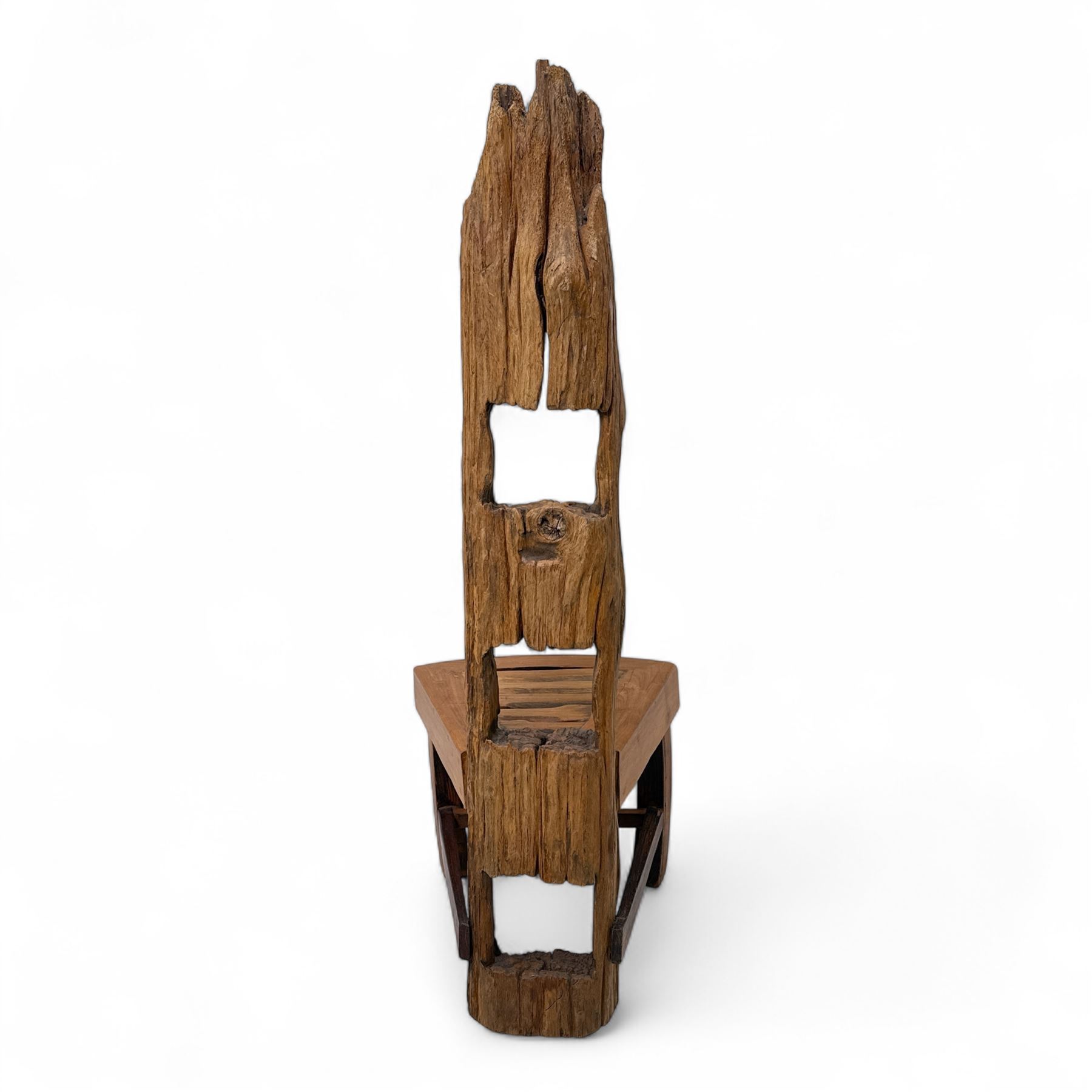 20th century driftwood sculptural hall chair, solid triangular seat over shaped apron, high ladder back formed from weathered and irregular timber, raised on curved legs united by H-stretcher