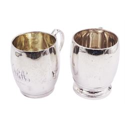 Two silver Christening mugs, the first an early 20th century example, with engraved monogram to front and scroll handle, hallmarked William Aitken, Birmingham 1911, together with a similar mid 20th century silver example of plain form with ribbed detail to foot and handle, hallmarked Walker & Hall, Sheffield 1953, tallest H8.5cm