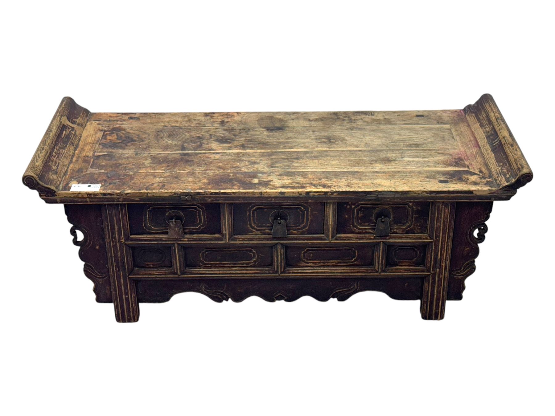Mid-19th century elm low altar table, rectangular top with scrolled ends, fitted with three small drawers, pierced and scroll carved brackets, on square moulded supports 