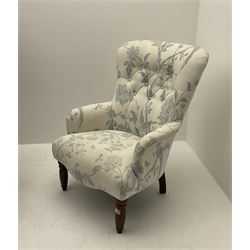 Victorian style armchair, upholstered in buttoned bird print fabric, raised on turned front supports 