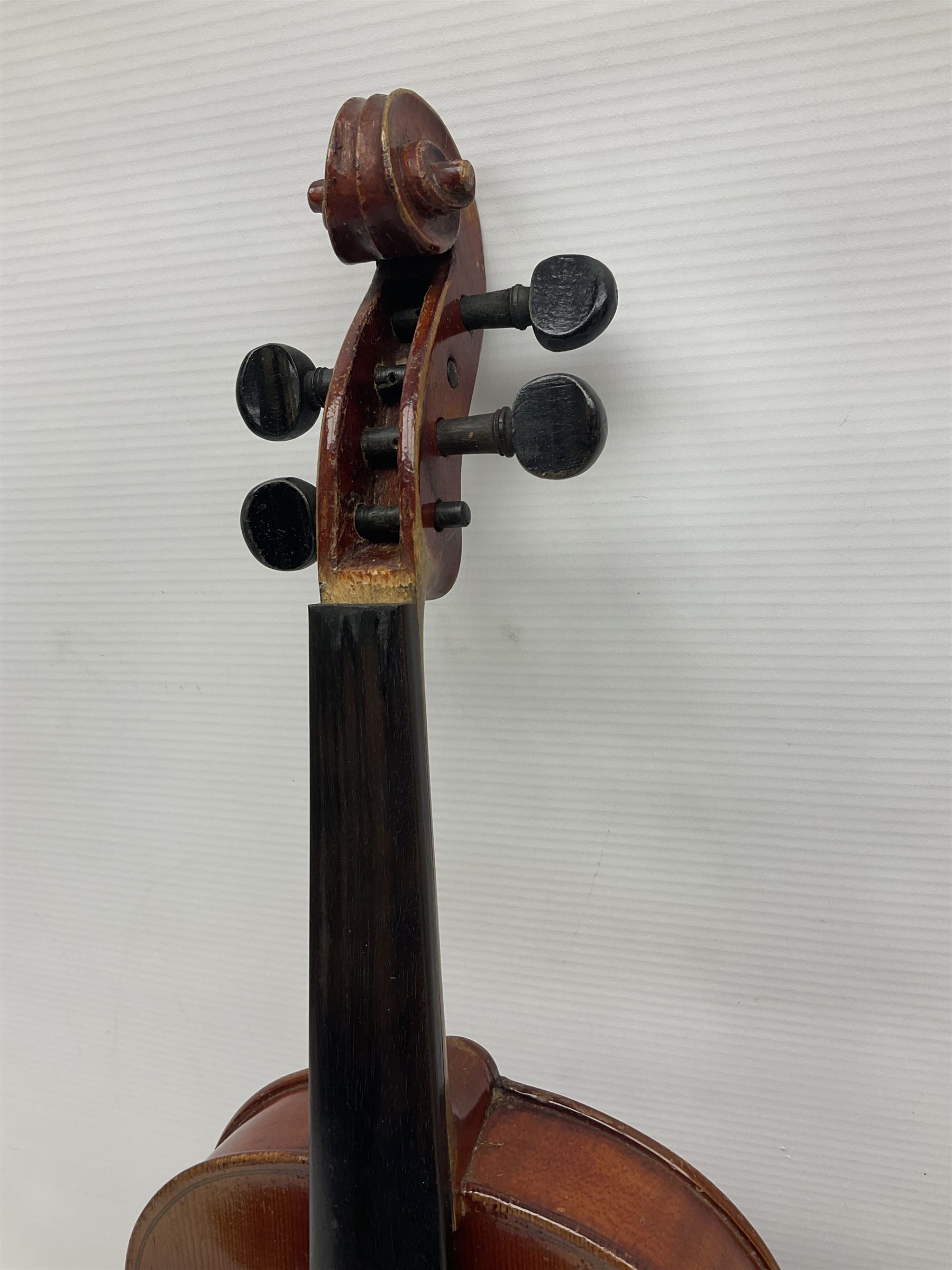 Late 19th century French three-quarter size 'Conservatory' violin with 34cm two-piece maple back and ribs and spruce top, the peg box inscribed 'Conservatory Violin Straduari', bears label 'Antonius Stradiuarius Cremonensis Faciebat Anno 1721' L55.5cm overall; in ebonised wooden 'coffin' case; and Saxony violin c1900 with 36cm two-piece maple back and ribs and spruce top; bears label 'Antonius Stradivarius Cremonensis Faciebat Anno 17**' L59cm overall; in carrying case (2)