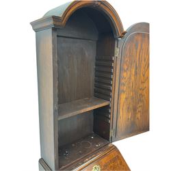 Small early 20th century Queen Anne style bookcase on bureau secretaire, the moulded arched pediment over mirrored door in shaped frame, the bureau fitted with fall front enclosing curved fitted interior, cushion moulded drawer over single drawer, on scroll and shell carved cabriole supports