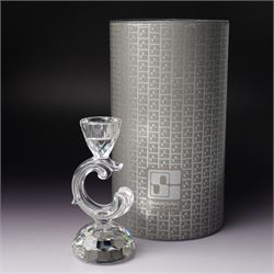 Pair of Swarovski Crystal candlesticks, boxed, together with two paperweights in the form of pineapples with gilt mounts, a large and small example, boxed (4)