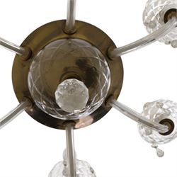 Early 20th century Continental glass and brass six branch chandelier, the central baluster column hung with graduated faceted glass drops, issuing six scrolling glass arms each fitted with candle sconces and drip pans, suspended from a fluted glass canopy