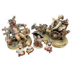 Group of Capodimonte figures, to include musical organ grinder with donkey and monkey example, tramp figure on bench, and choir boy and girl figures