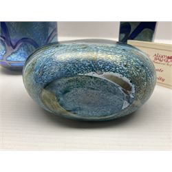Two Isle of White glass vases, by Alum Bay Glass, both with blue swirl design upon an iridescent mottled blue/green ground, together with a Gozo Glass vase of pebble form, with similar design, H12cm
