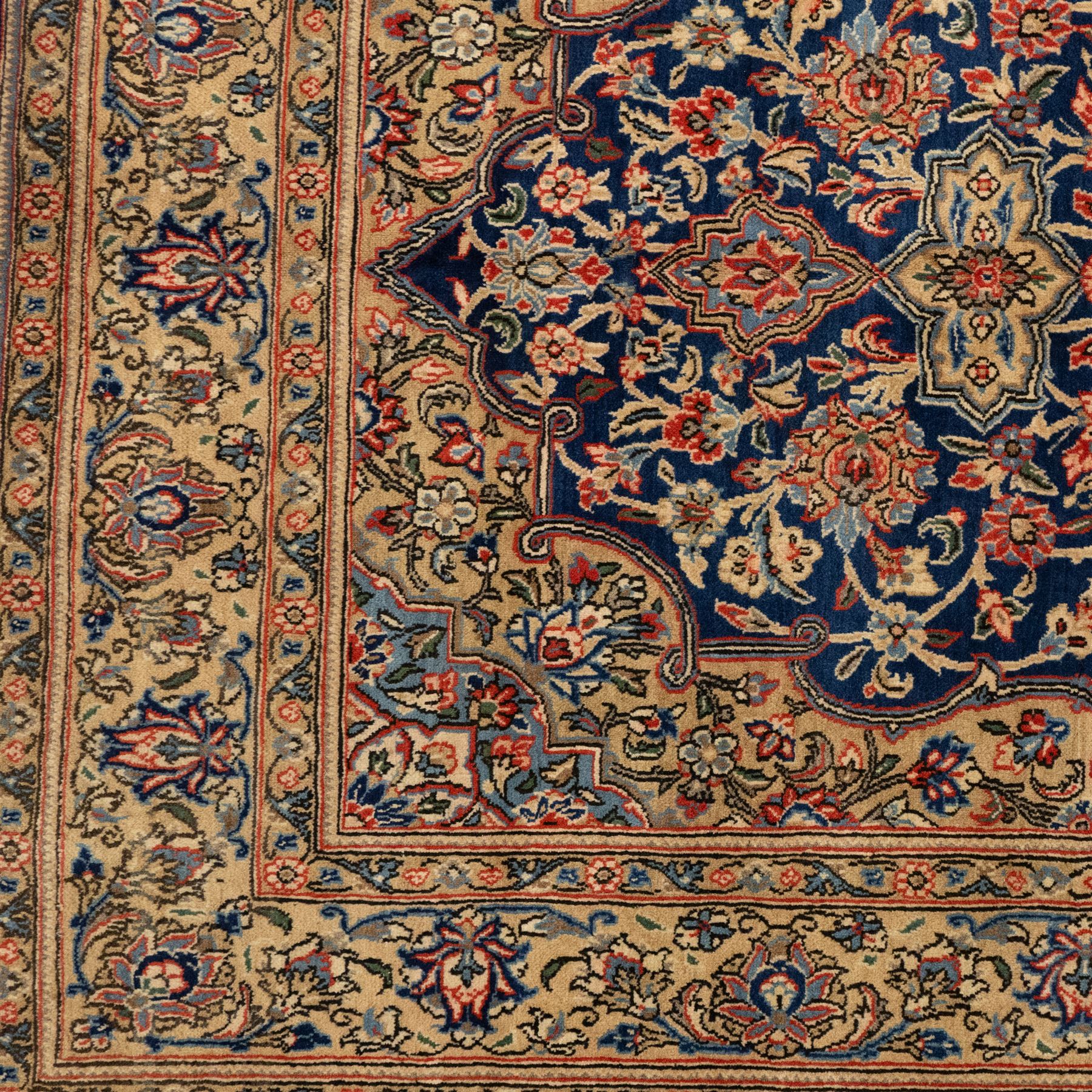 Persian Kashan rug, navy field with lobed central medallion and scrolling floral sprays, ivory spandrels within a palmette and vine border