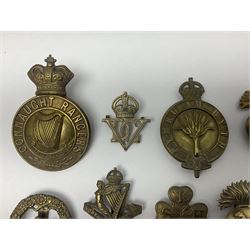 Fourteen cap badges of Irish interest including Royal Dublin Fusiliers inscribed to the slider 'From A. O'Connor 2nd Batt. Dec.2nd 1915', Connaught Rangers, South irish Horse Yeomanry, Inniskilling Fusiliers, Royal Irish Regiment etc; and seven Welsh badges including South Wales Borderers, Welsh Guards, 3rd Bn. Monmouthshire Regt. etc (21)