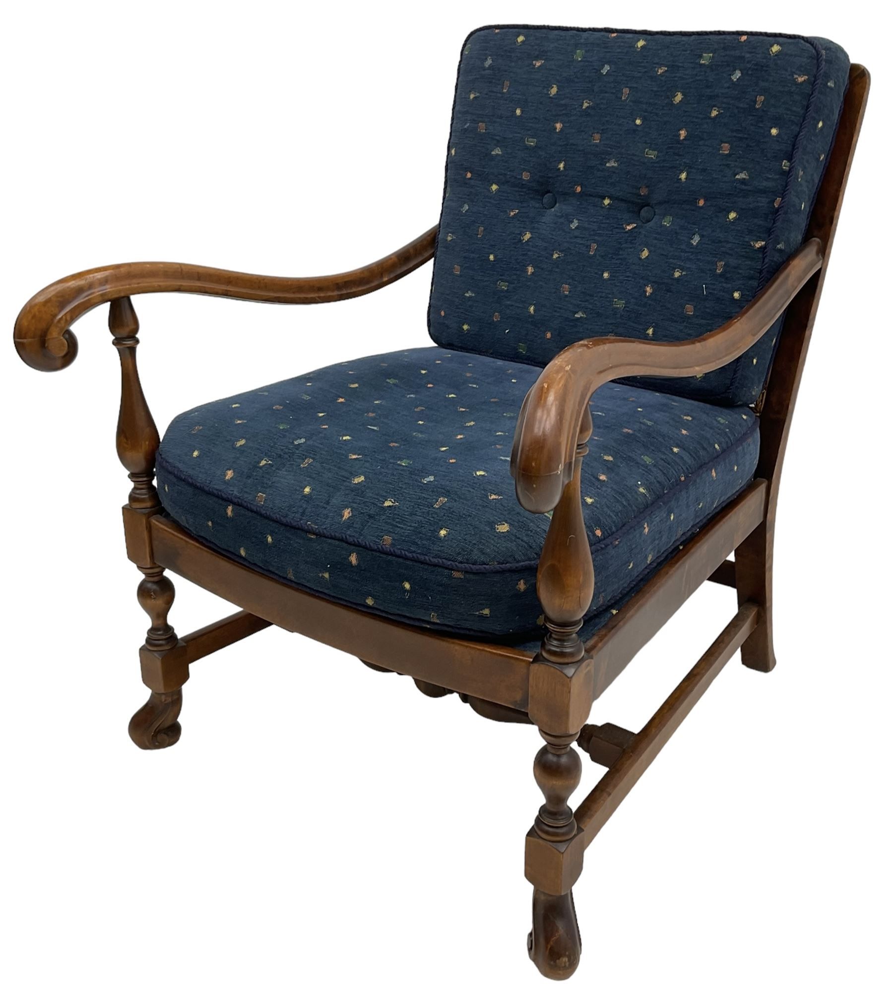 Early 20th century stained beech framed armchair, cane panel back over scrolled arm terminals, raised on turned supports united by turned H-stretcher, with patterned blue upholstered loose back and seat cushions