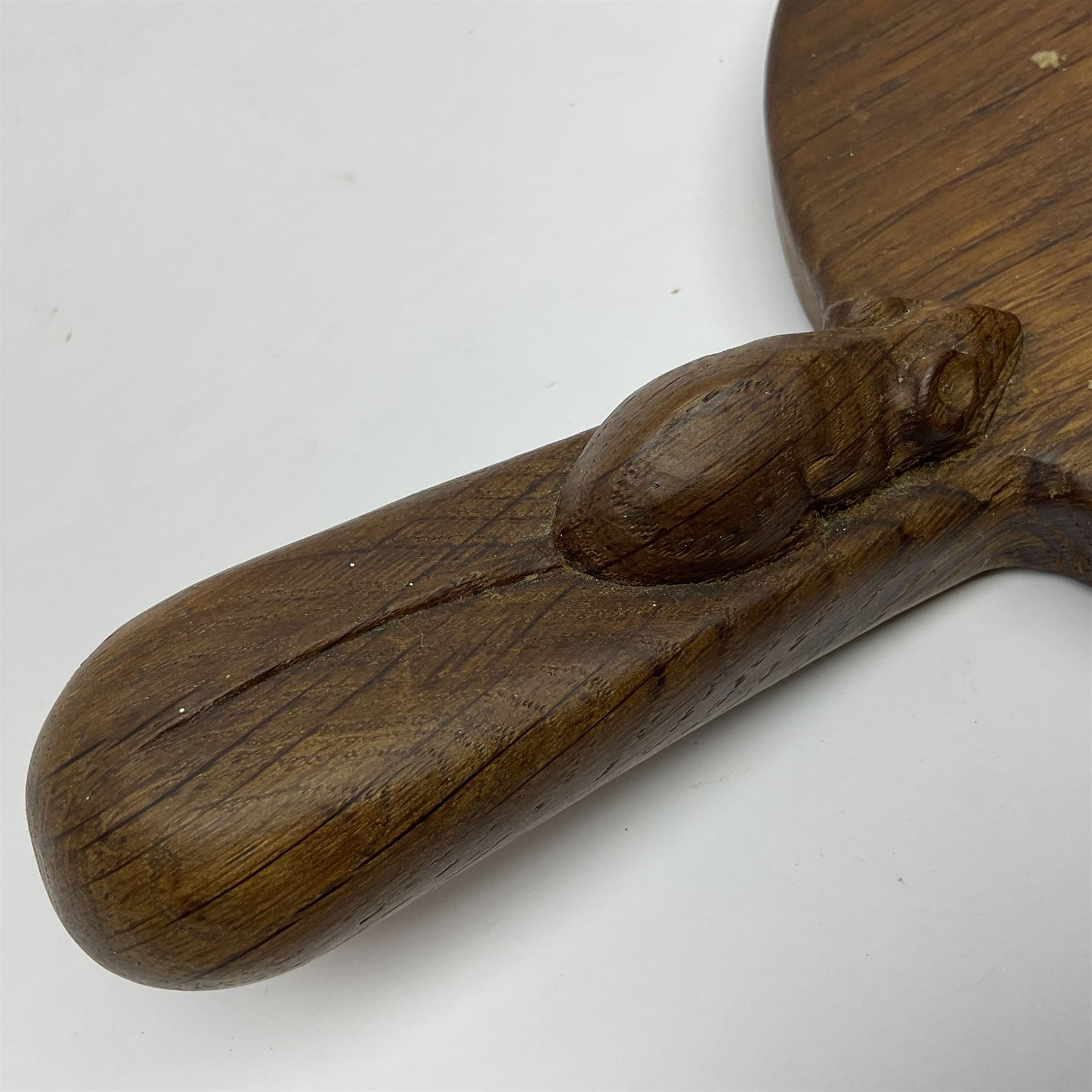 Mouseman - oak kidney-shaped cheeseboard, the handle caved with mouse signature, by the workshop of Robert Thompson, Kilburn 