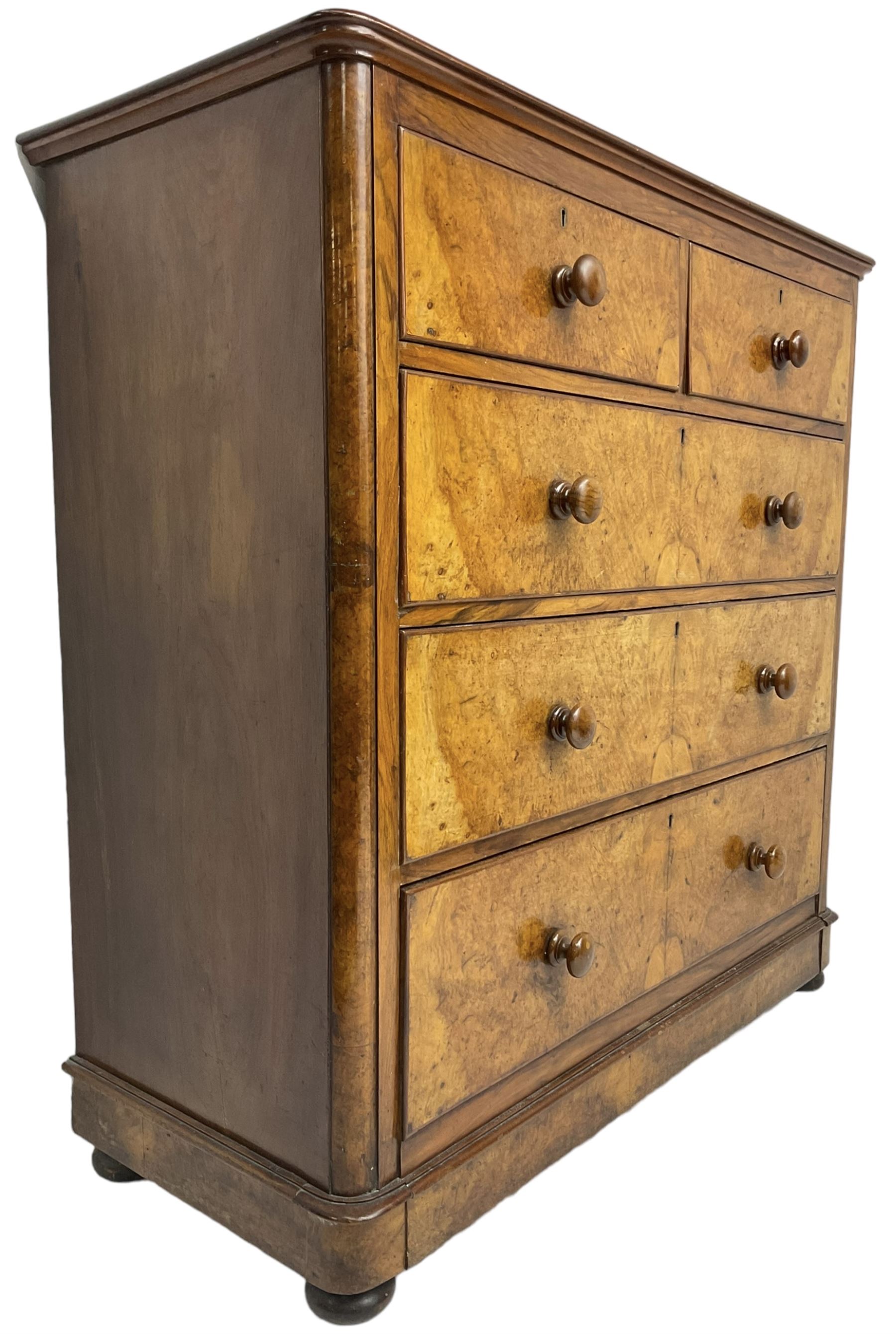 Early 20th century figured walnut chest, fitted with two short over three long drawers with bookmatch veneer facias, each with turned walnut handles, skirted base over compressed bun feet 