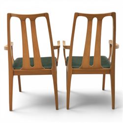 A pair of Nathan 'Highback Carvers' and a 20th century nest of teak tables, (Tables W65cm, D38cm, H49cm)
(Carvers W57, H97)